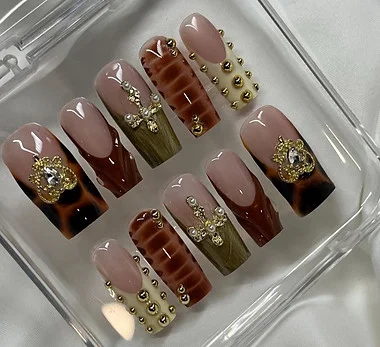 Custom handmade press-on nail set in a clear case — tortoiseshell french tips with gold studs, made at Richmond Nails & Lash Bar